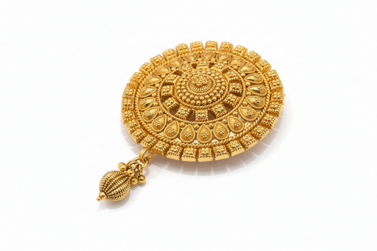 Gold decorative hair brooch with intricate design on a white background