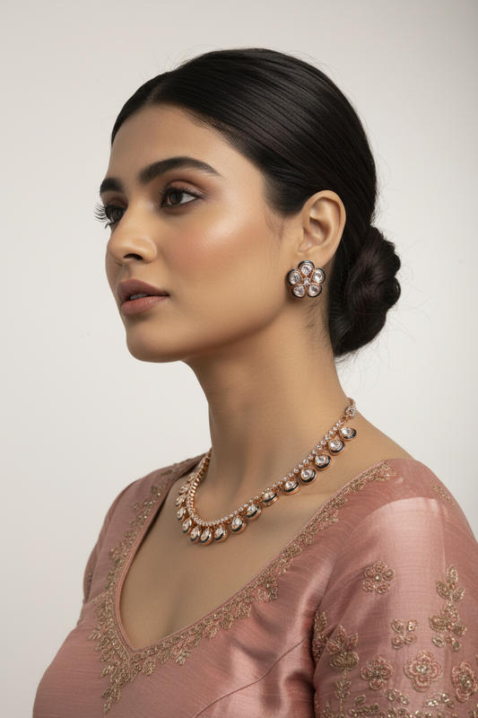 Woman wearing a pink saree with intricate designs and jewelry against a plain background