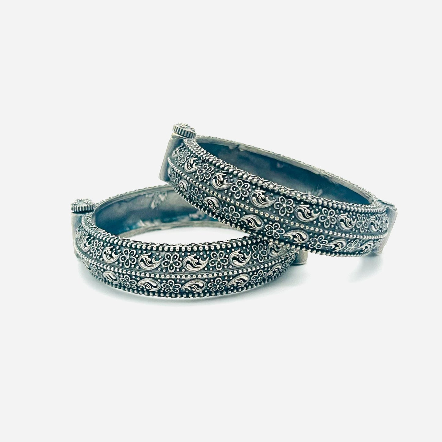 Two silver bangles on a white background