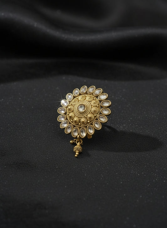 Gold decorative earring on a light gray background