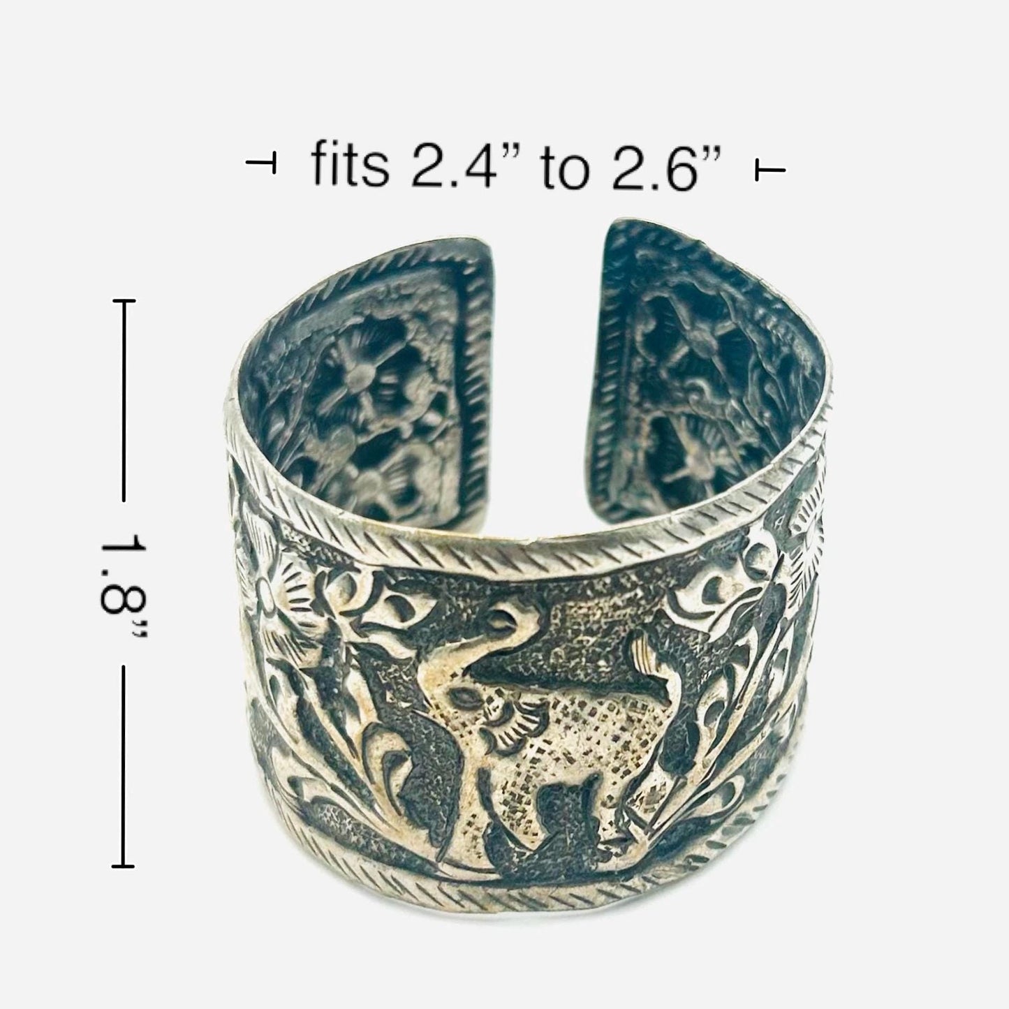 Silver elephant design cuff bracelet with measurements on a white background