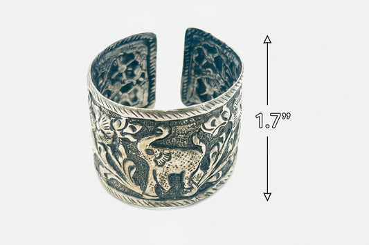 Silver elephant design cuff bracelet with measurements on a white background