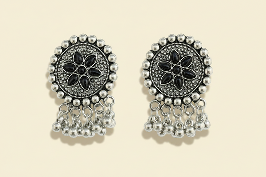 oxidize Pair of silver and black traditional floral earrings on a white background