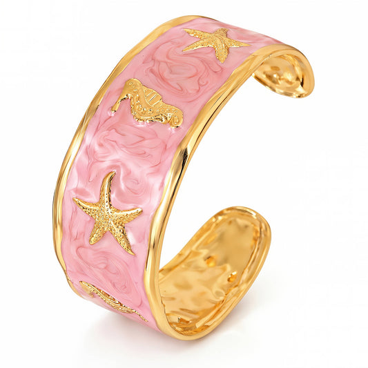 Pink and gold bracelet with starfish designs on a white background