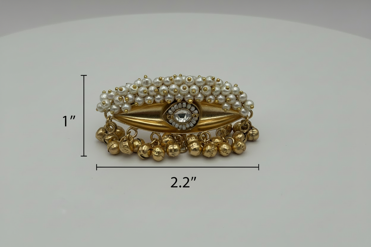Decorative ring with gold and pearl design on a white background