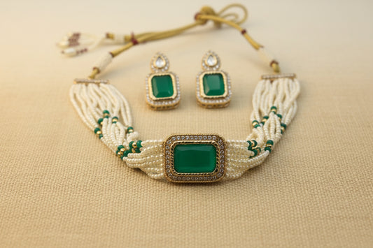 Jewelry set with necklace and earrings on a white plate