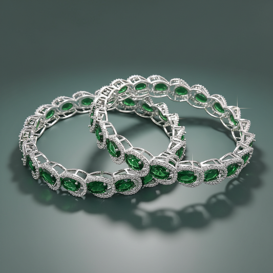 Silver bracelet with green gemstones on a dark gray background
