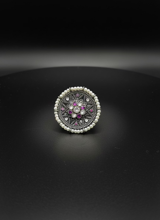 Decorative ring with gemstones on a white background