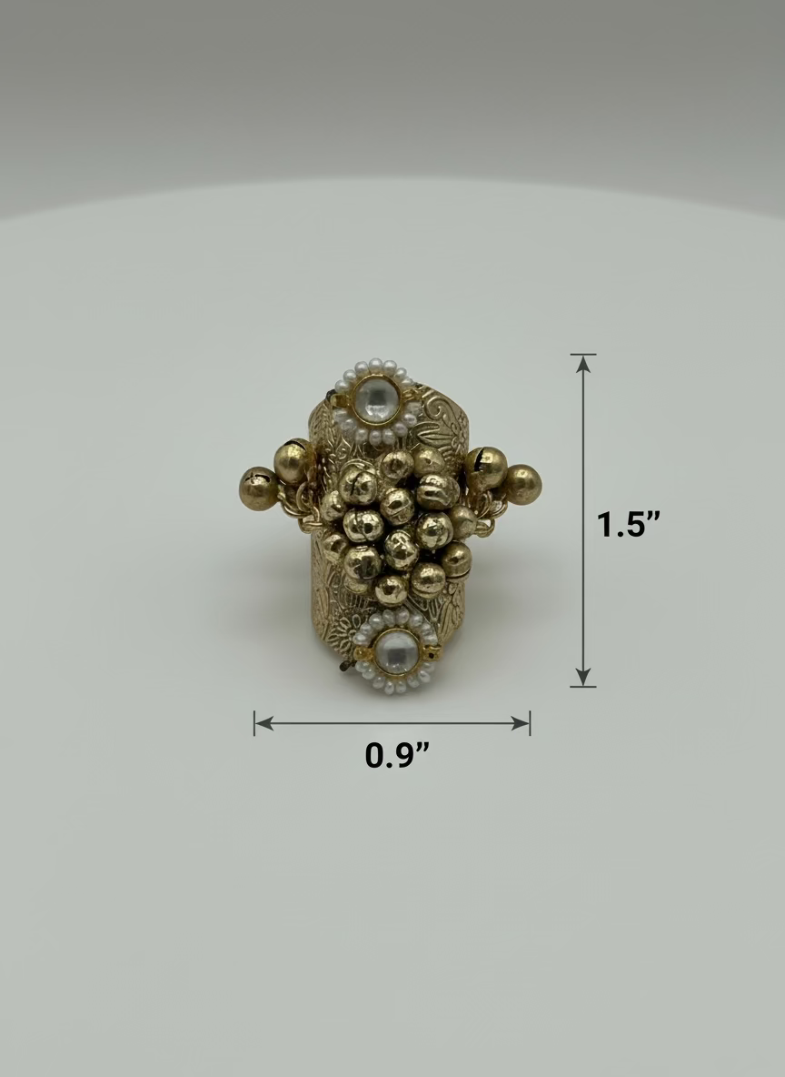 Gold ring with intricate design on a light gray background