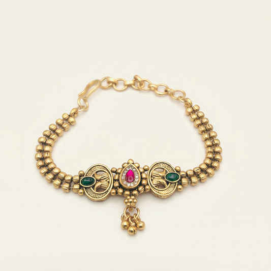 Gold bracelet with gemstones on a white background
