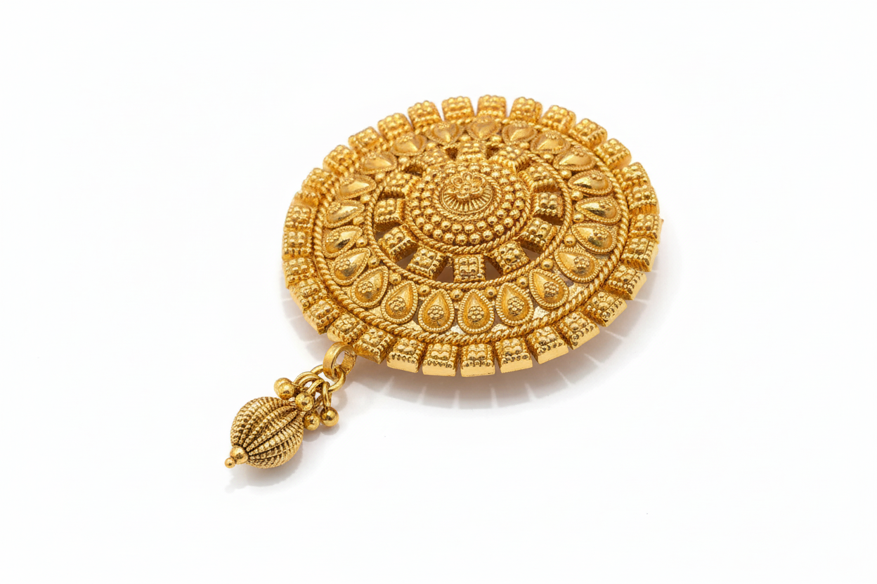 Gold decorative hair brooch with intricate design on a white background