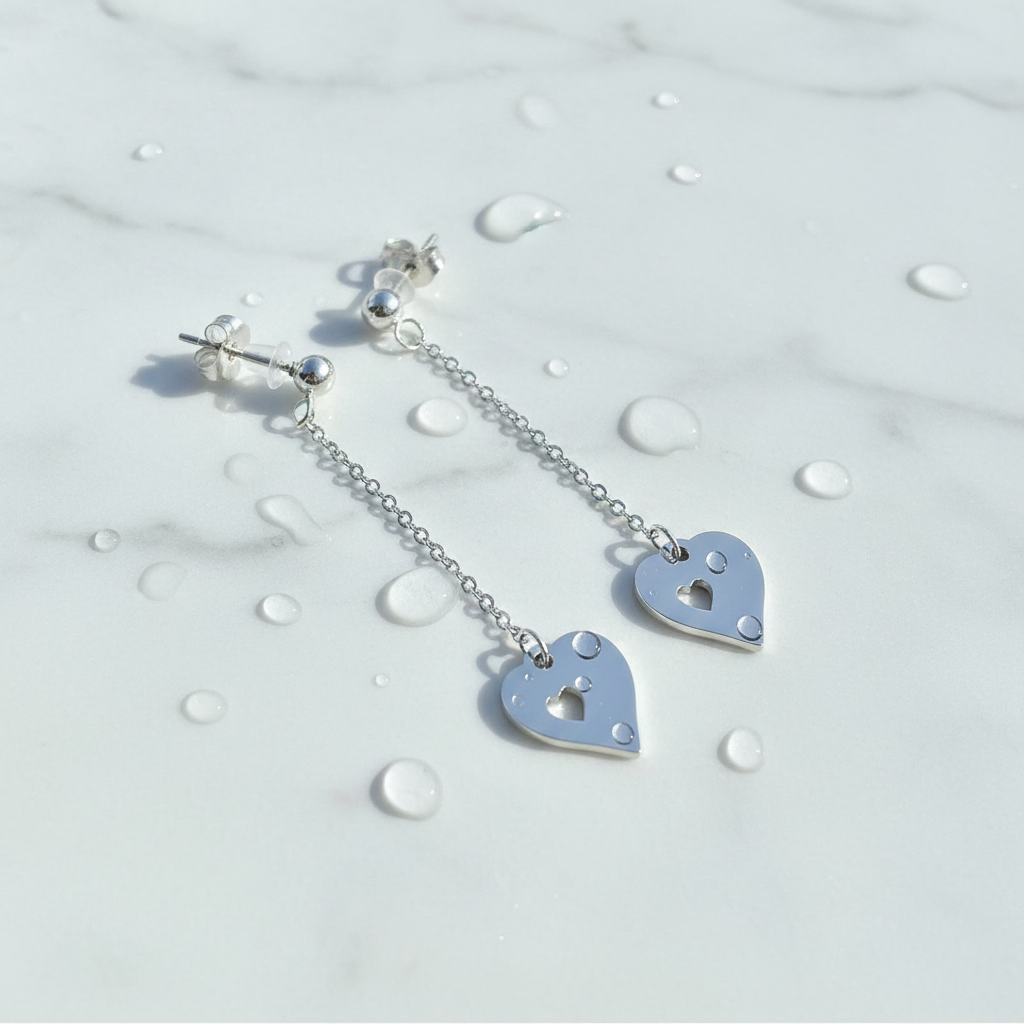 Silver heart-shaped earrings with a lock design on a light background