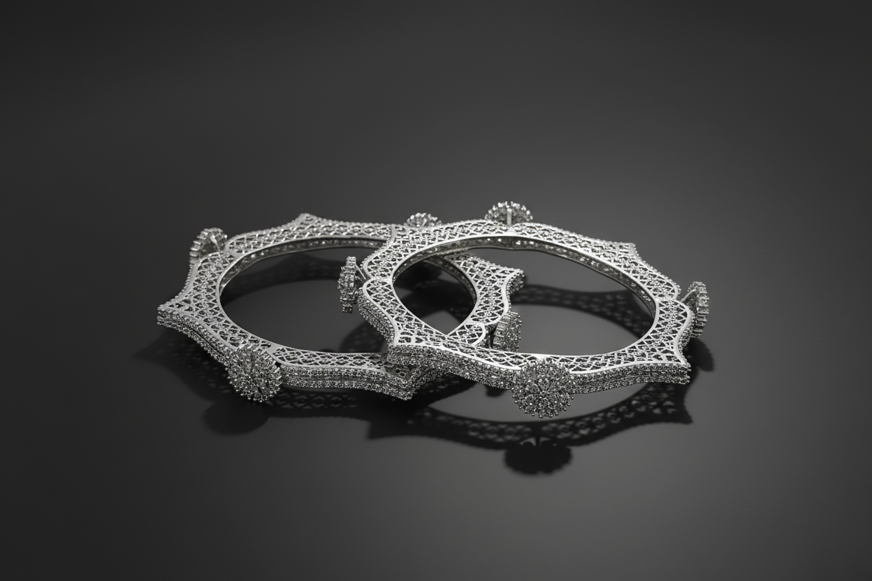 Two diamond-encrusted silver  bangels on a black background