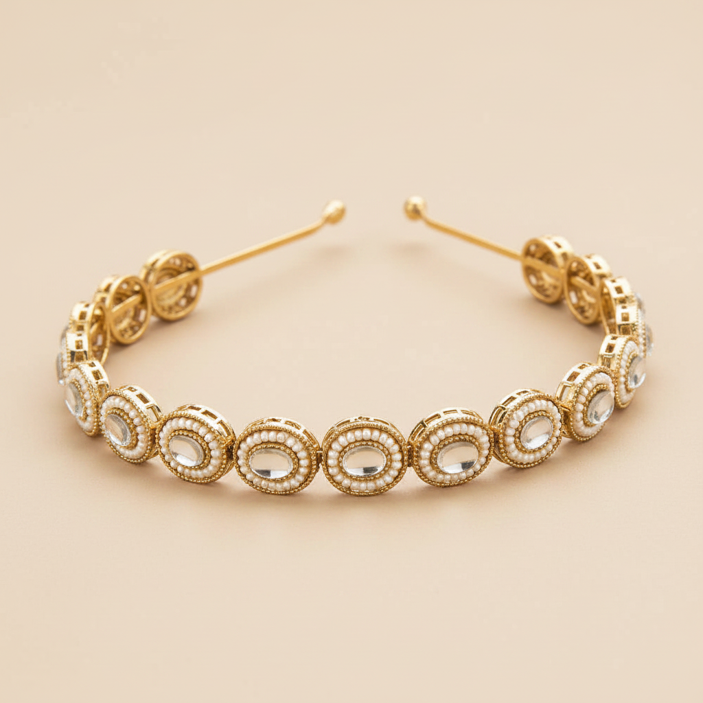 Gold pearls headband with circular design and clear stones on a beige background