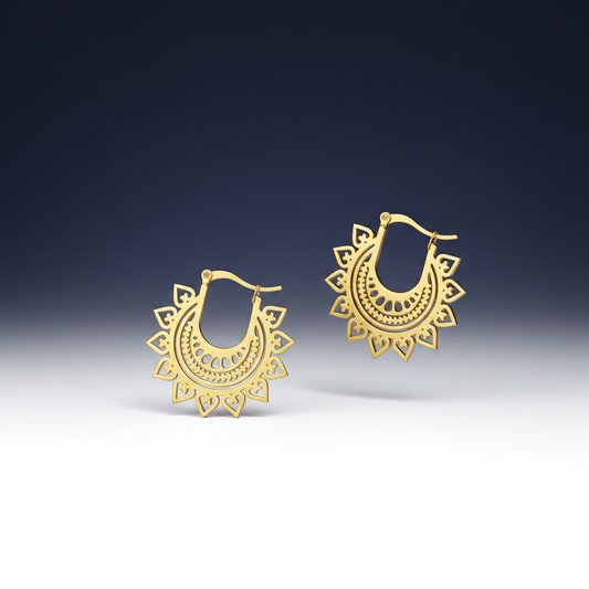 Gold hoop earrings with intricate designs on a white background