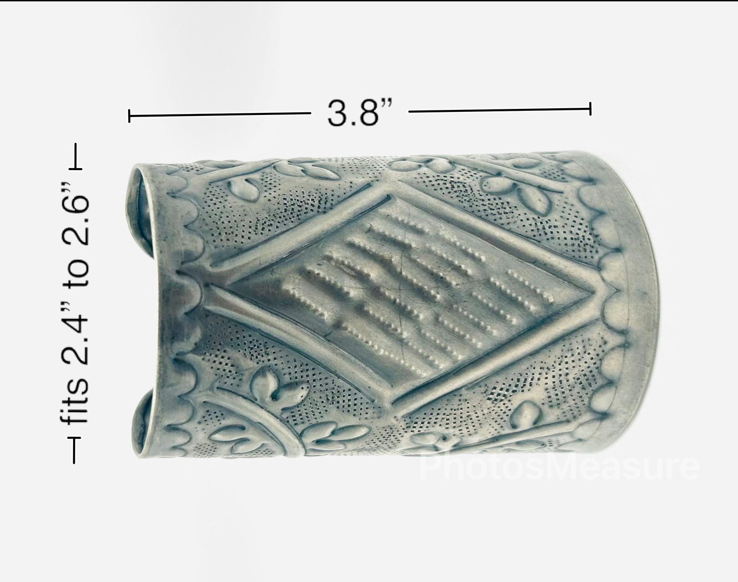 Decorative cylindrical object with measurements on a white background