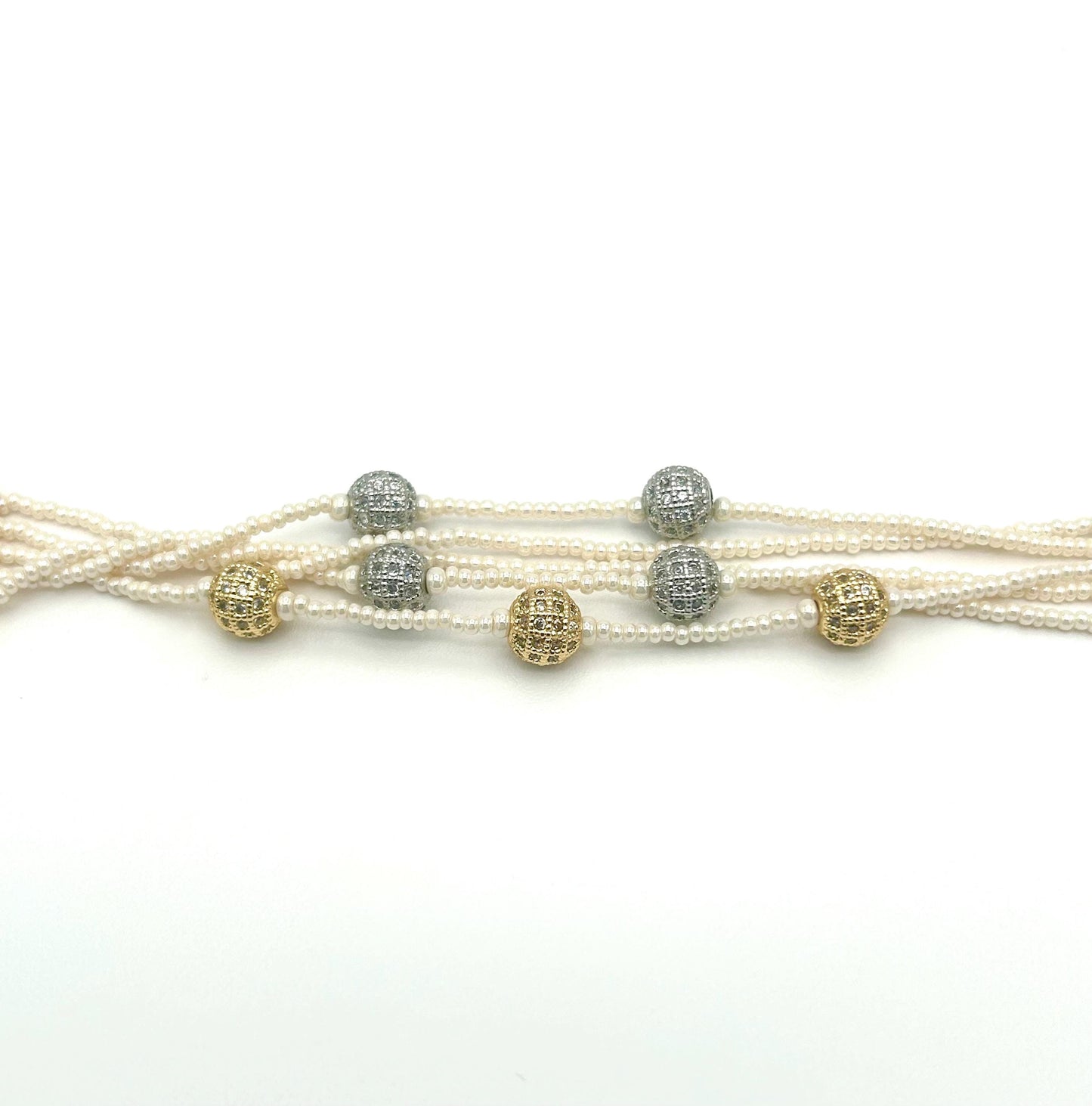 Multi-strand pearl necklace with gold and silver beads on a white background