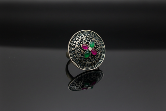 temple Silver black tone ring with colorful gemstones on a reflective black surface