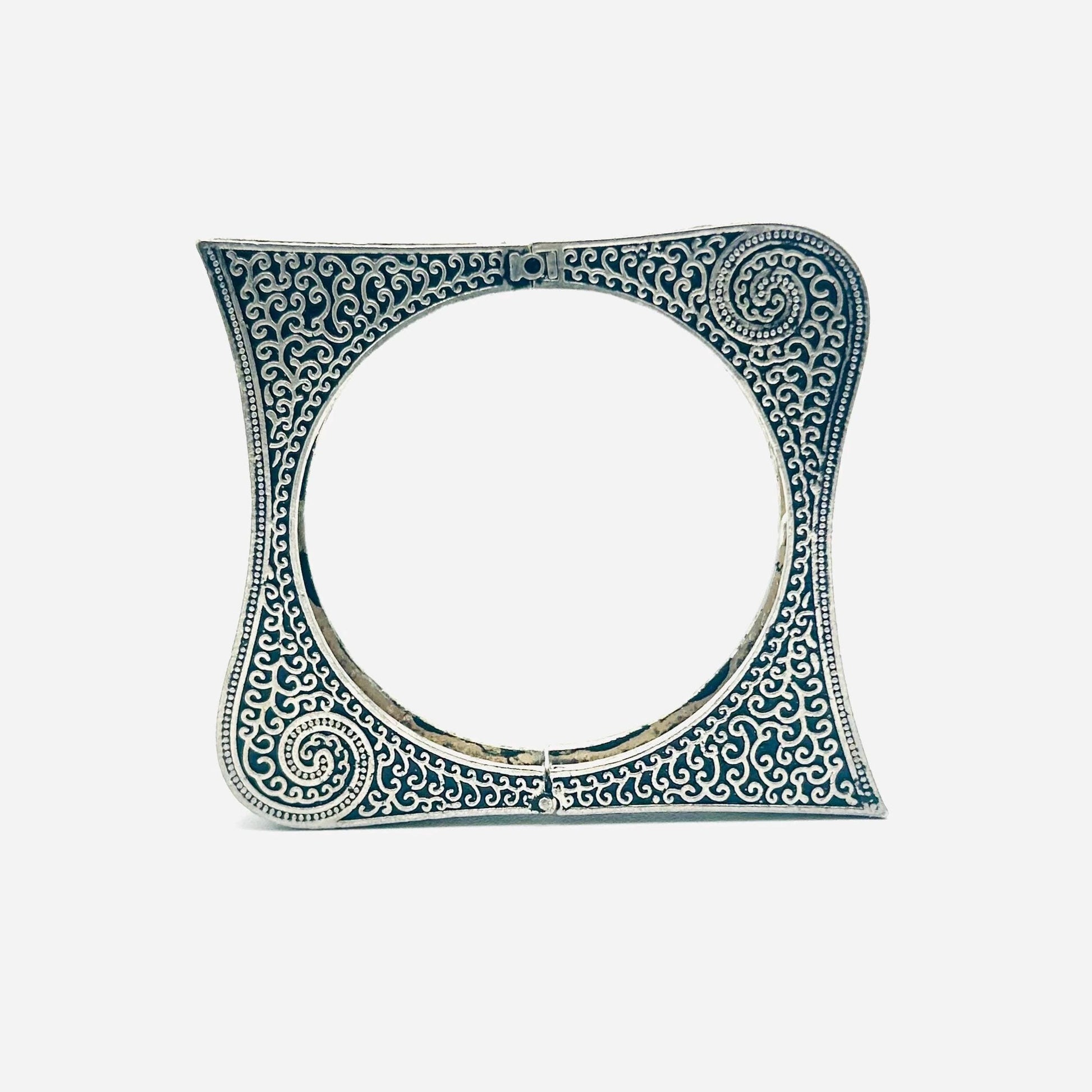 Decorative ceramic tile with intricate blue patterns on a white background