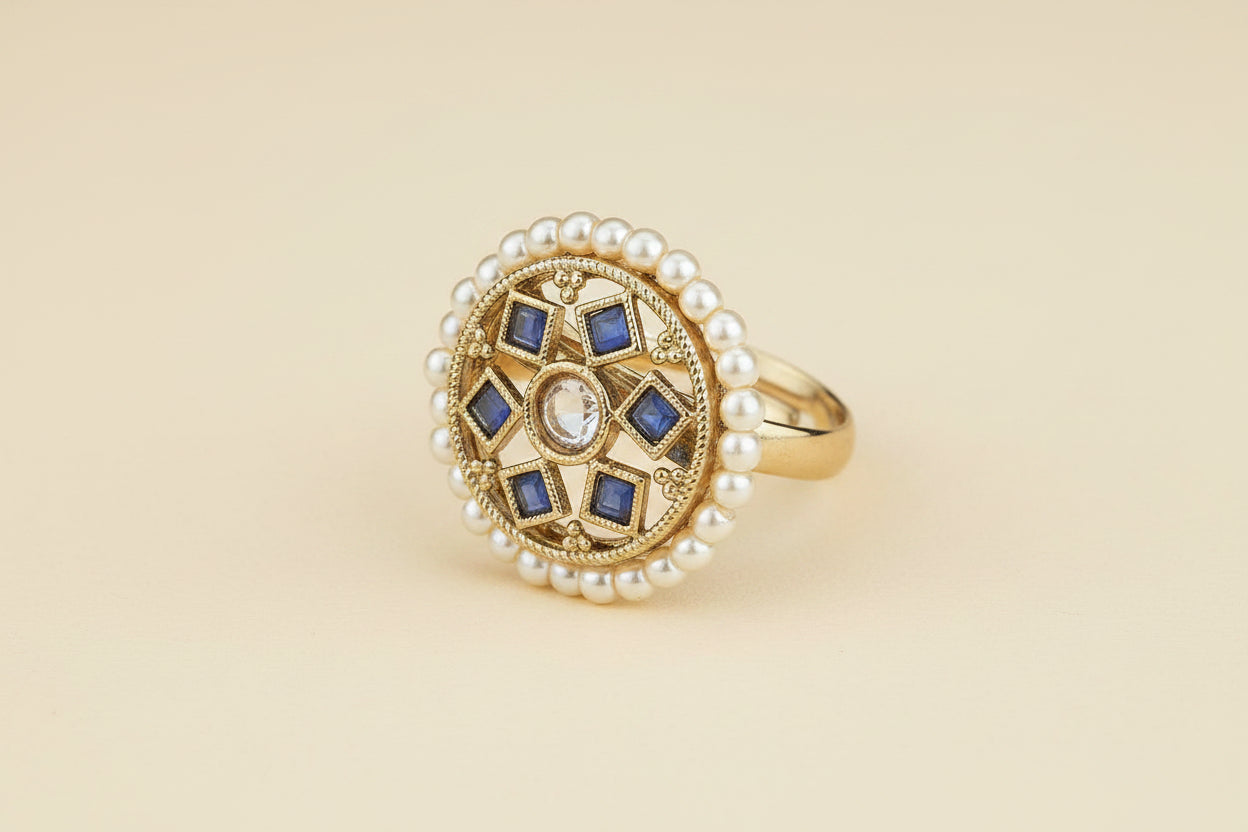 Statement ring with pearls beaded and blue stones traditional ring on a light being background 