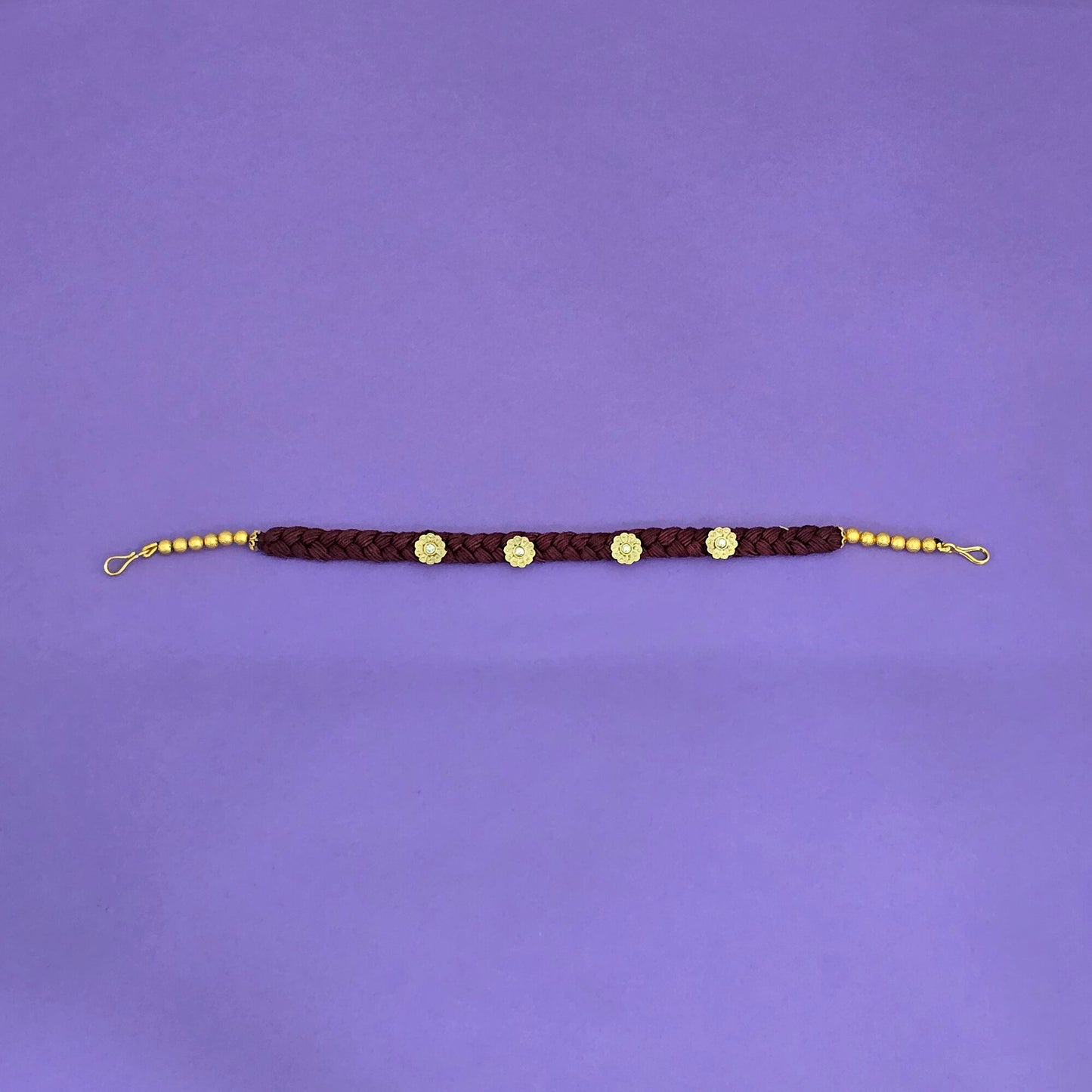 head jewelry hair band with gold beads on a purple background