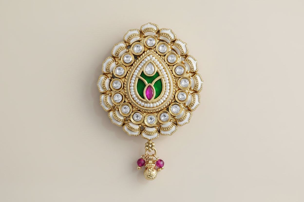 kundan decoretive  Dupatta safety pin Brooch with gold, green, and red colors on a pink background
