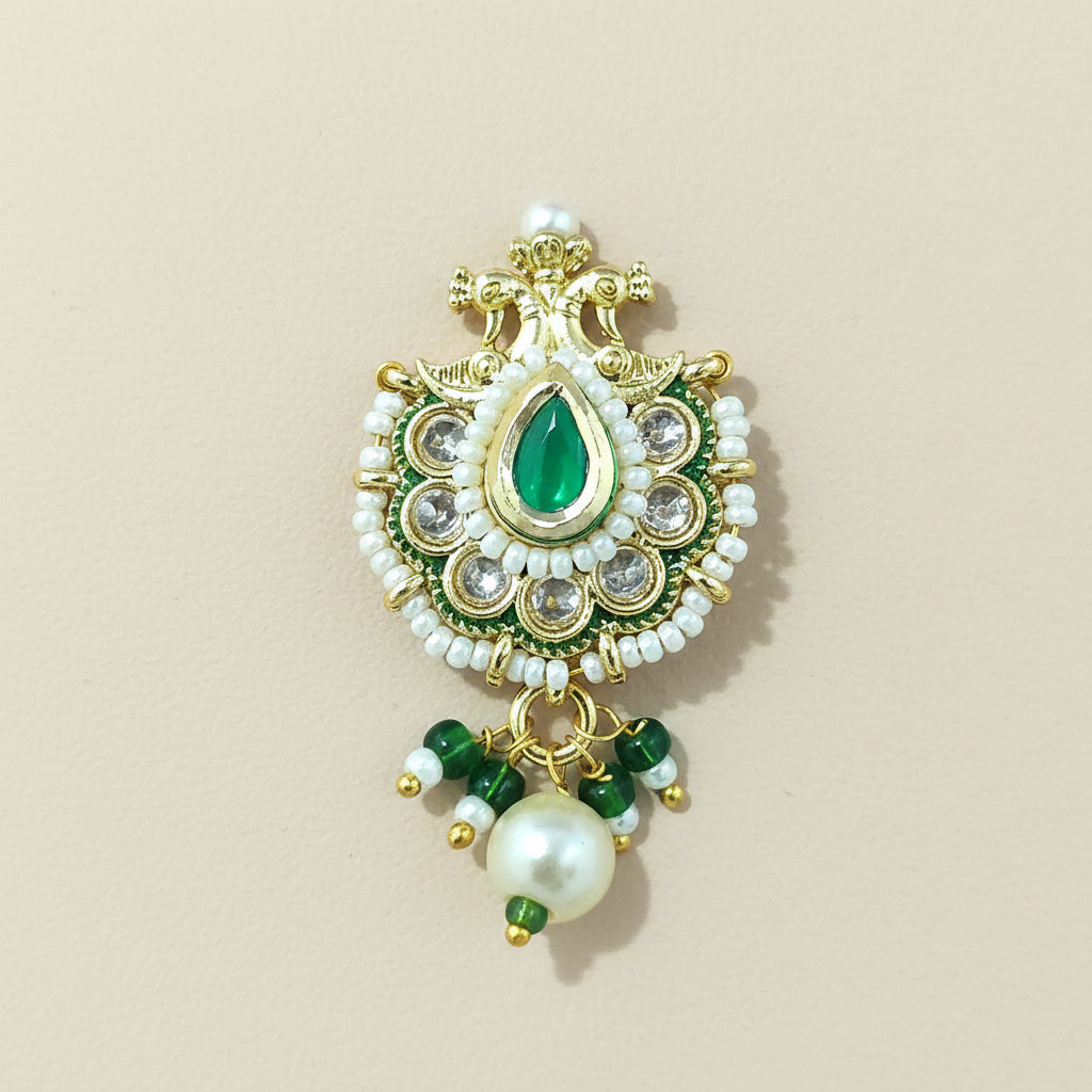 Decorative traditional nose ring with green gemstone and pearl on a #F7F1E8 background