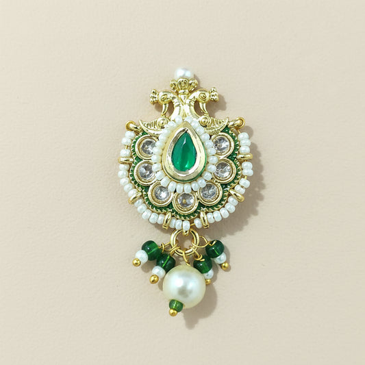 Decorative traditional nose ring with green gemstone and pearl on a #F7F1E8 background