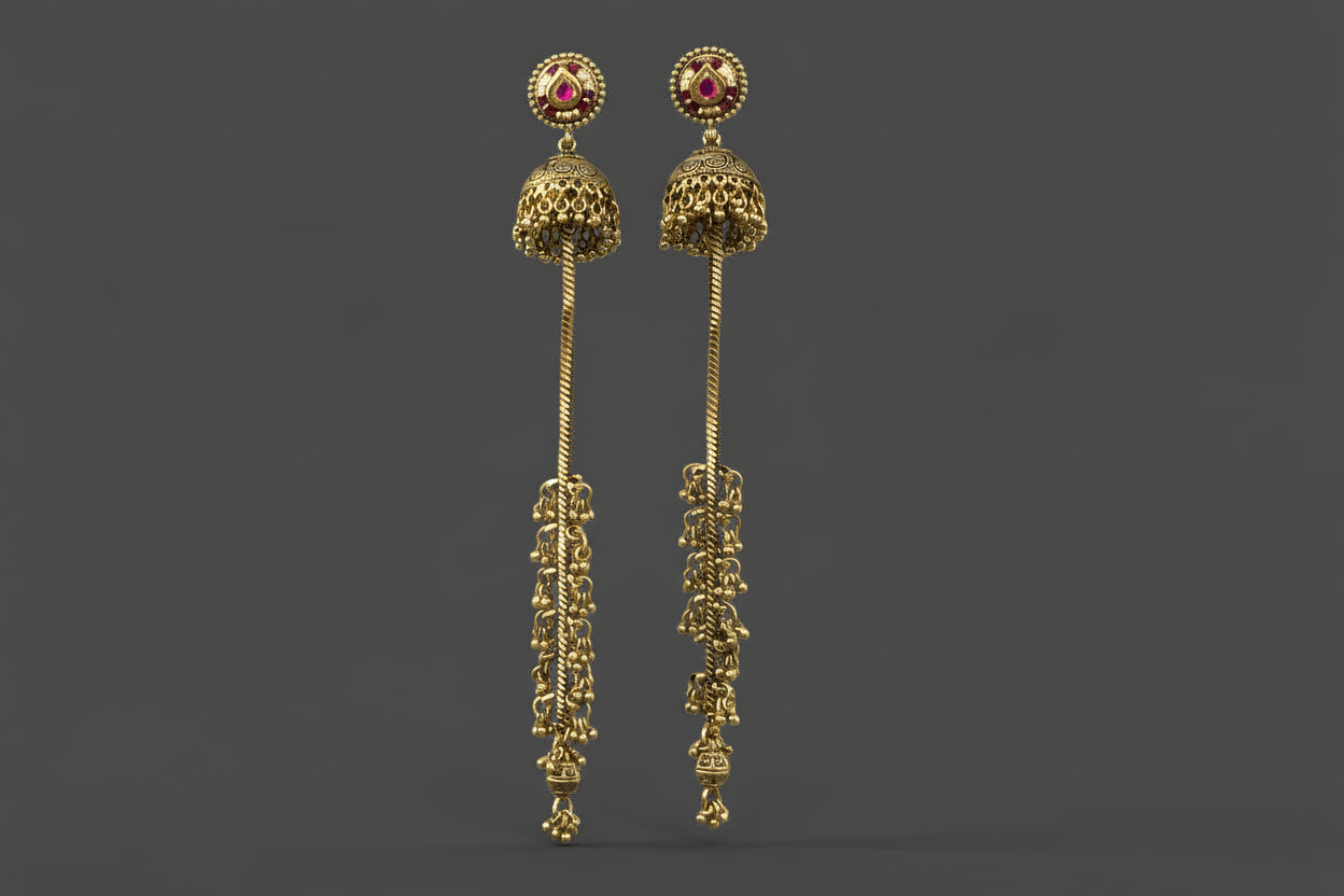 Gold plated long  red jhumka earrings with intricate designs on a light gray background
