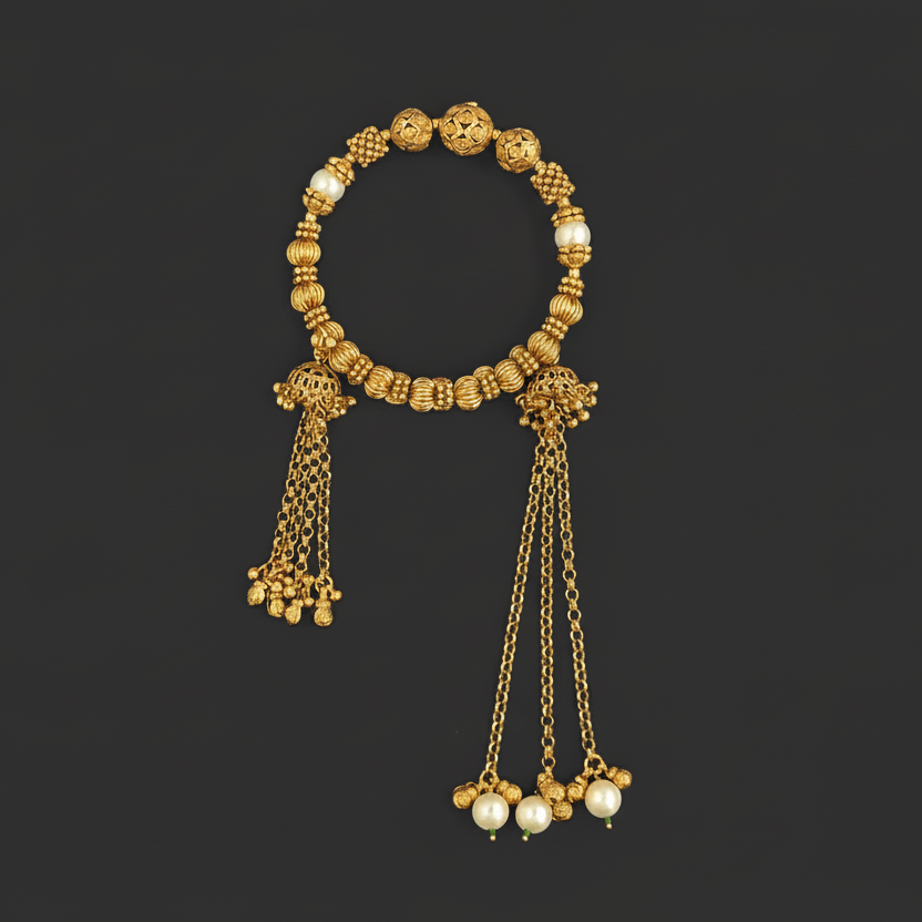Gold plated bracelet with pearl bracelet on a black background