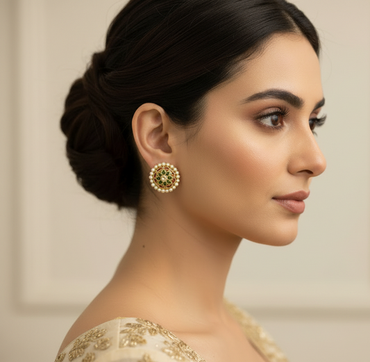 Woman wearing traditional earrings with a neutral background