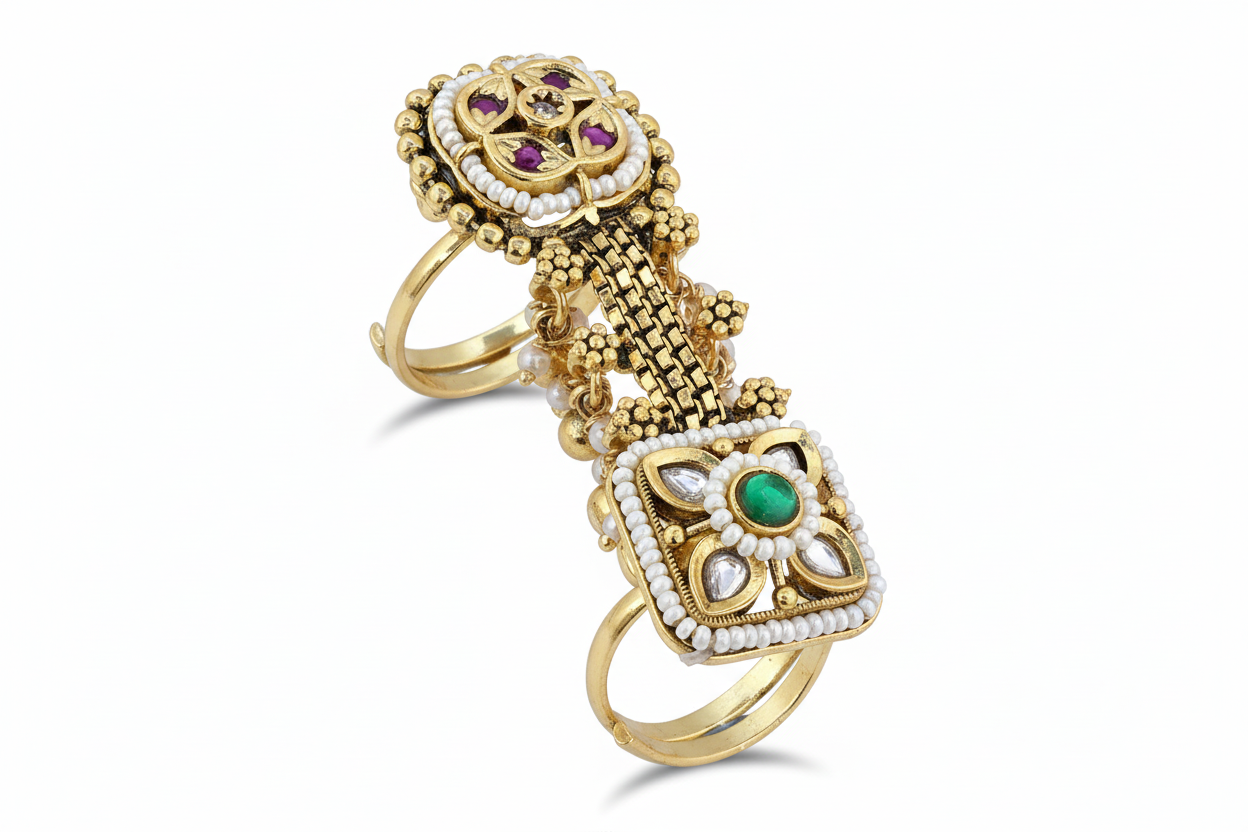 Gold two bands long ring with intricate design and gemstones on a white background