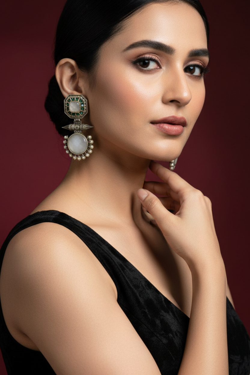 Woman wearing elegant earrings against a dark background