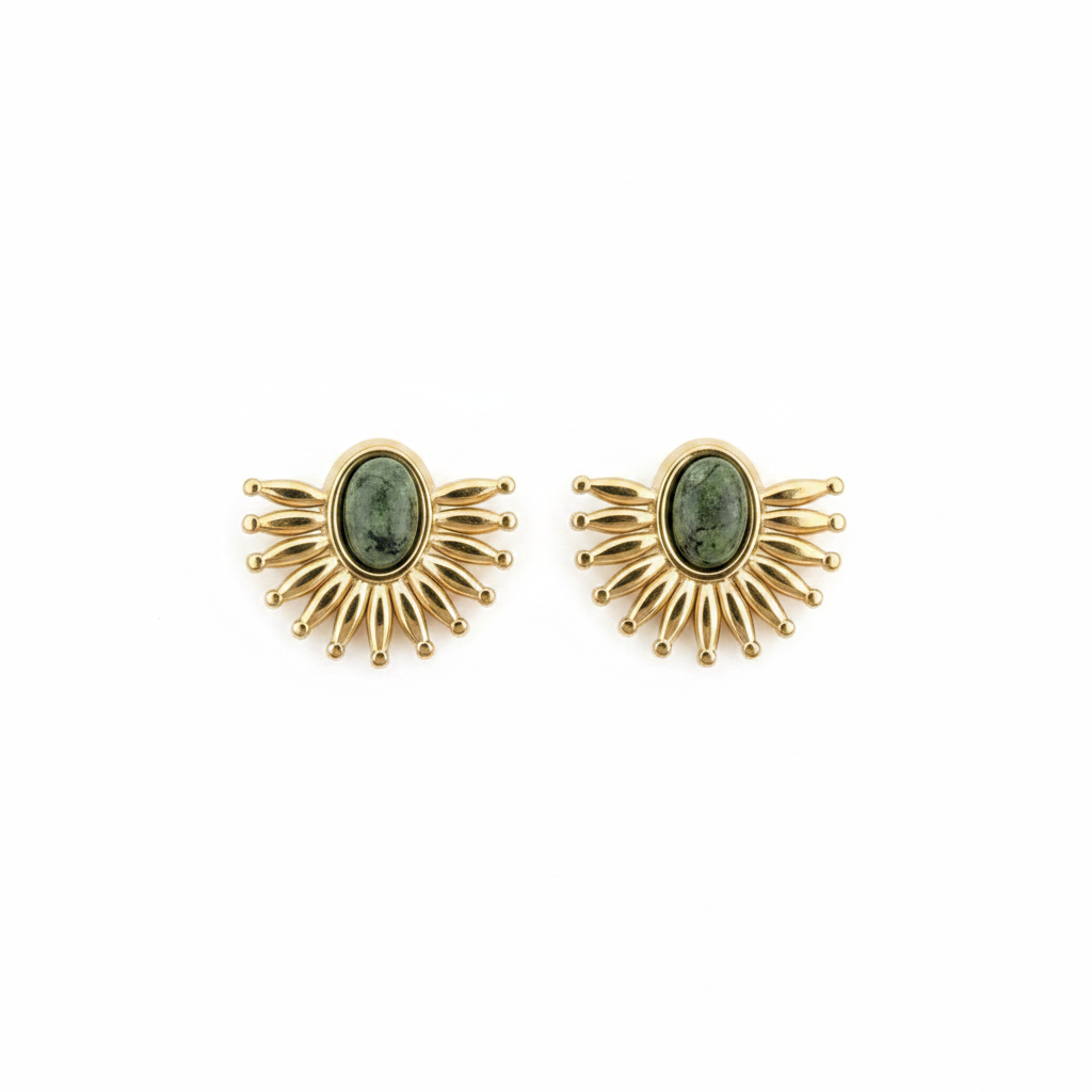 Gold sunburst earrings with green gemstones on a white background