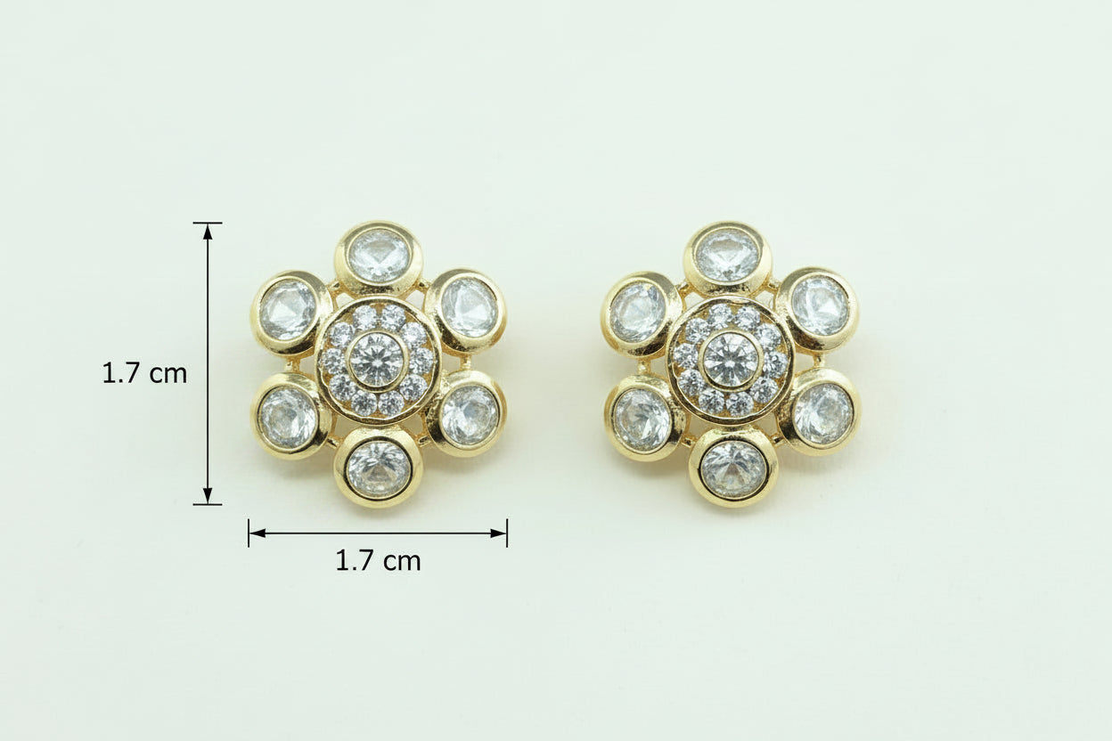 Pair of gold plated floral earrings with gemstones on a purple background