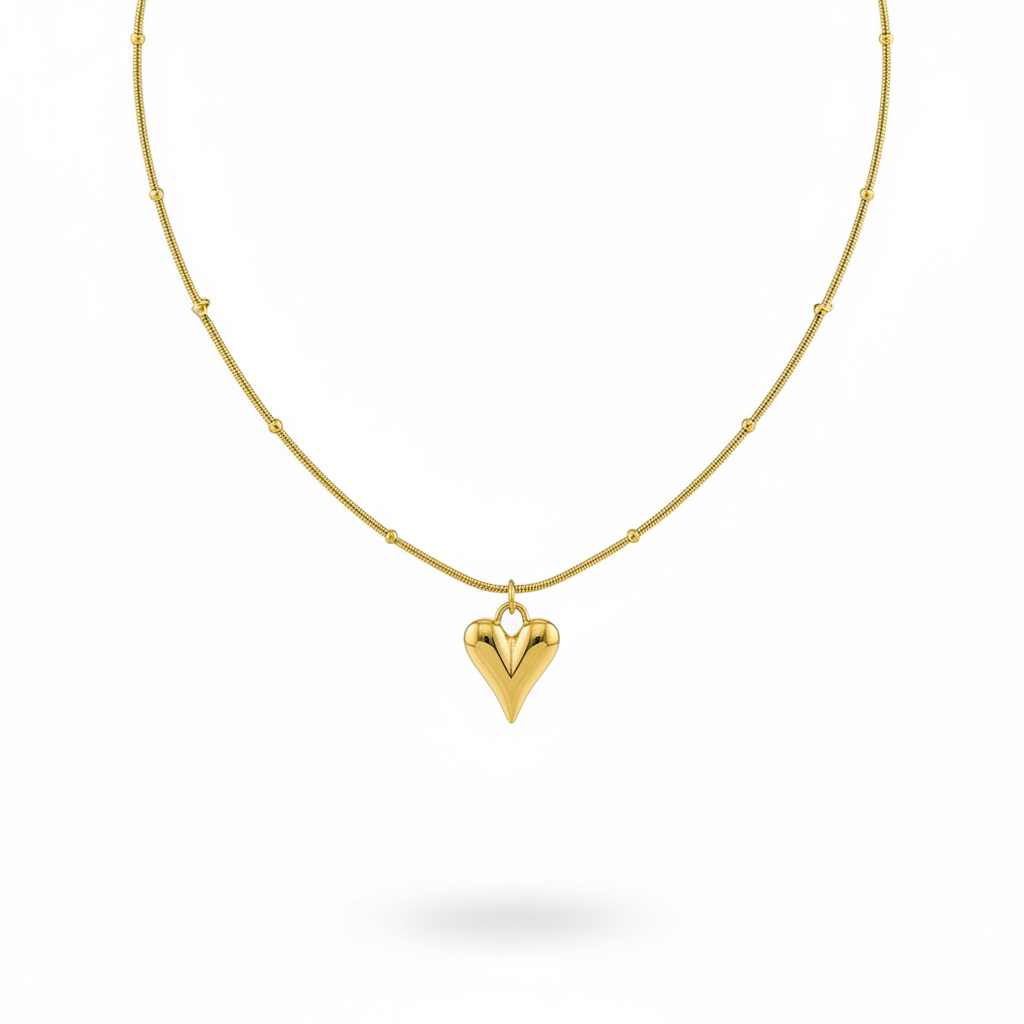 Gold necklace with a heart-shaped pendant on a white background