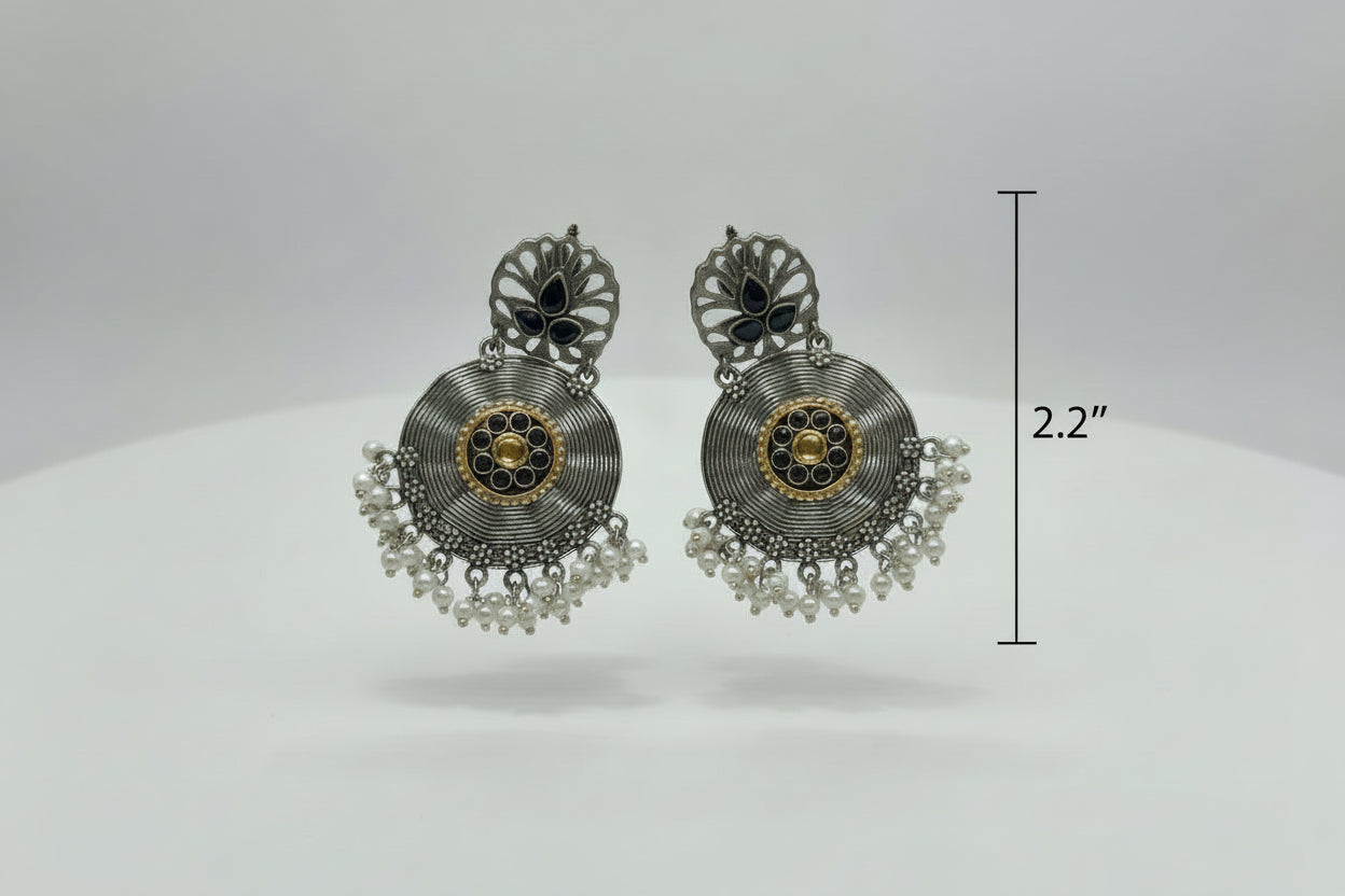 Pair of ornate earrings on a white background