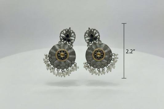 Pair of ornate earrings on a white background