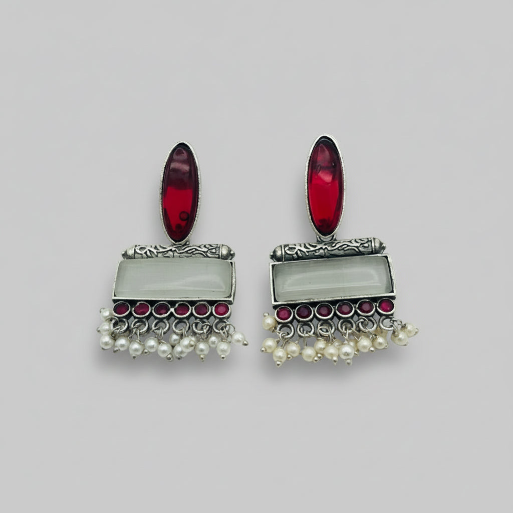 Pair of earrings with red stones and pearl-like elements, shown with measurements on a white background.