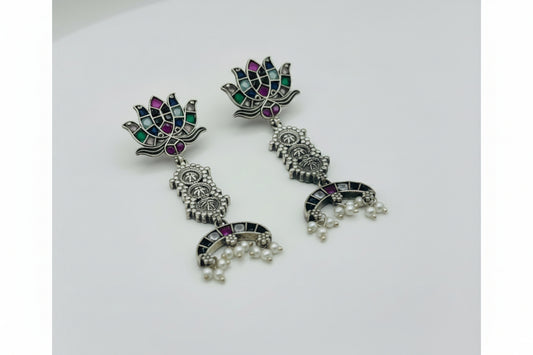 Pair of multi color stone temple earrings with floral design on a white background
