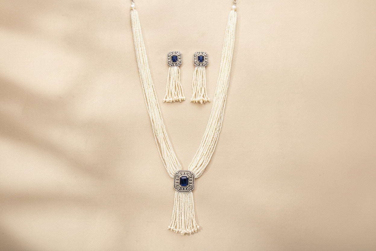 Necklace and earrings set with tassels on a brown background