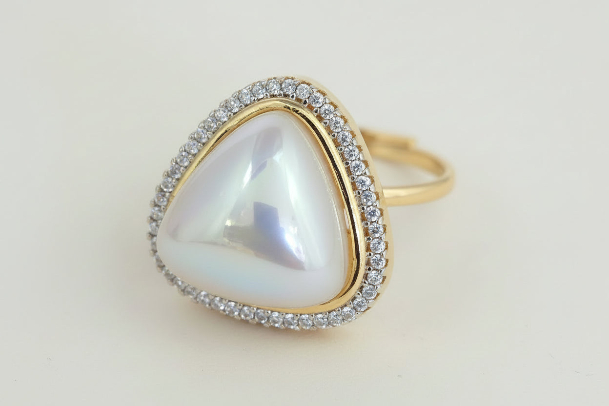 AD pearl Gold plated ring with a heart-shaped gemstone on a white  background