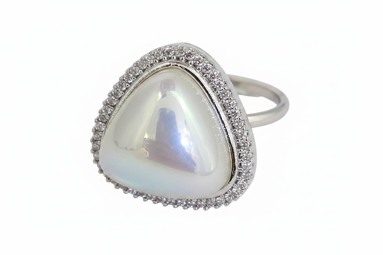 Heart-shaped pearl ring with silver border on a white background