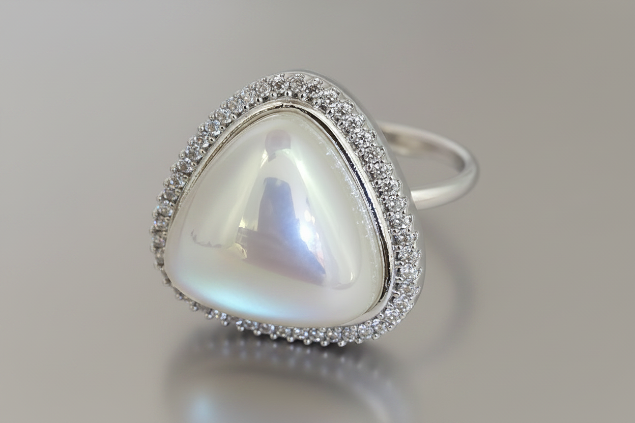 Silver ring with a large heart-shaped gemstone on a gray background