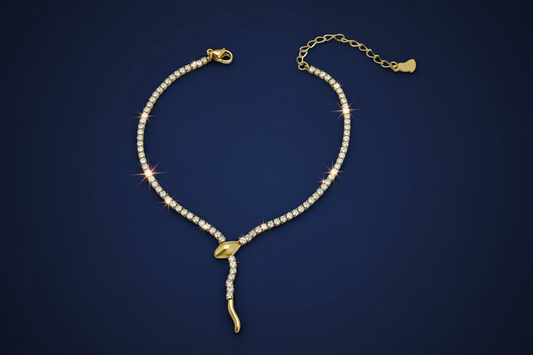 Gold anklet with clear stones on a dark blue background