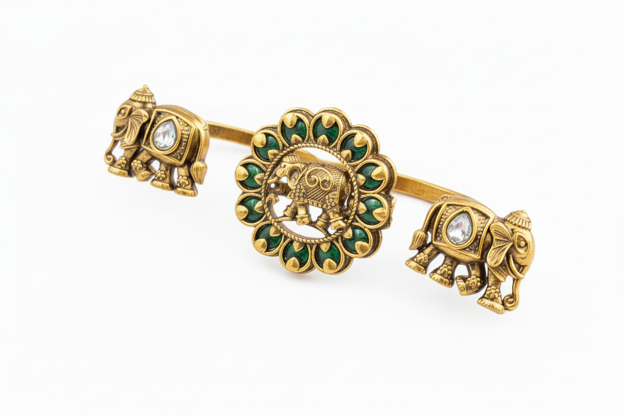 Gold and green elephant-shaped rings on a white background