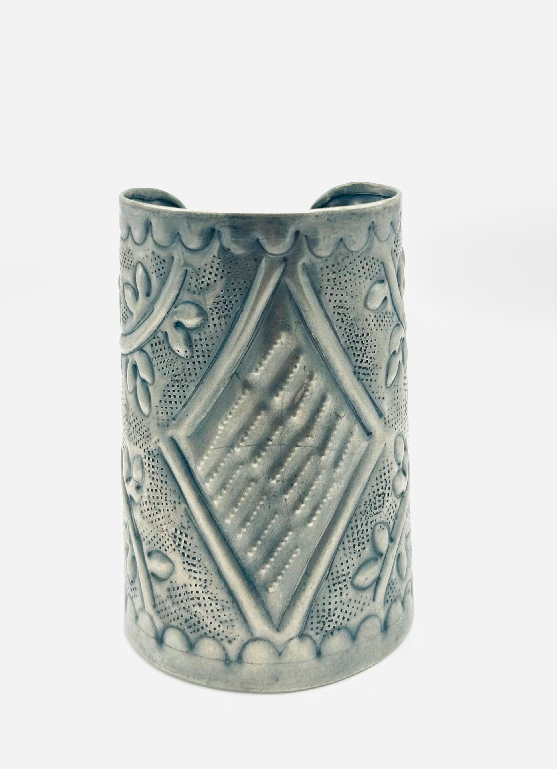 Decorative ceramic vase with geometric patterns on a white background