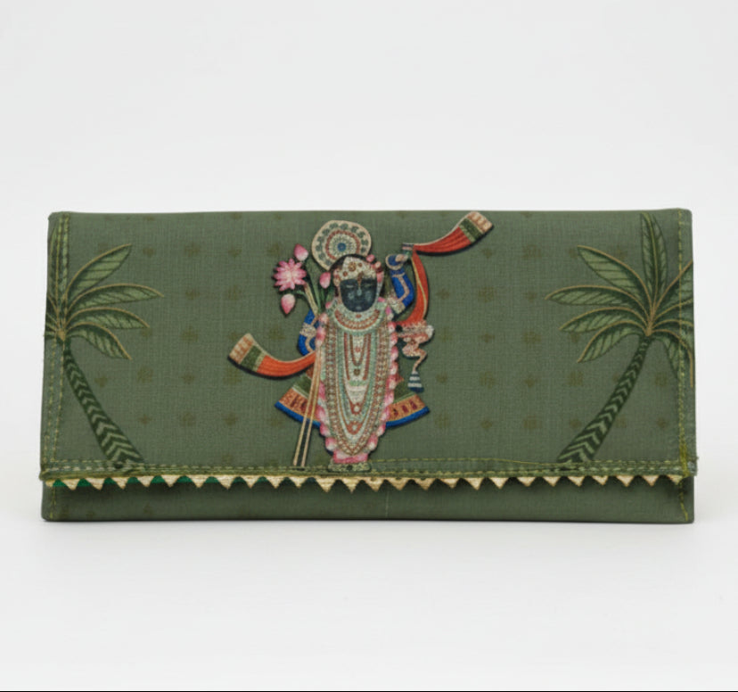 Green clutch bag with decorative design on a white background