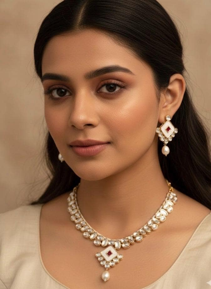 Woman wearing a necklace and earrings with a neutral background