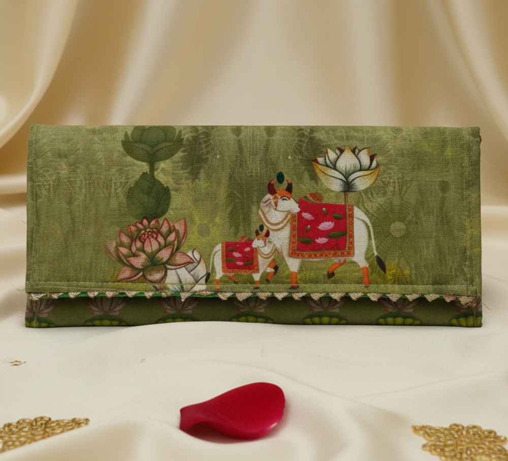 Decorative gift envolope with artistic cow lotus design on a white fabric background